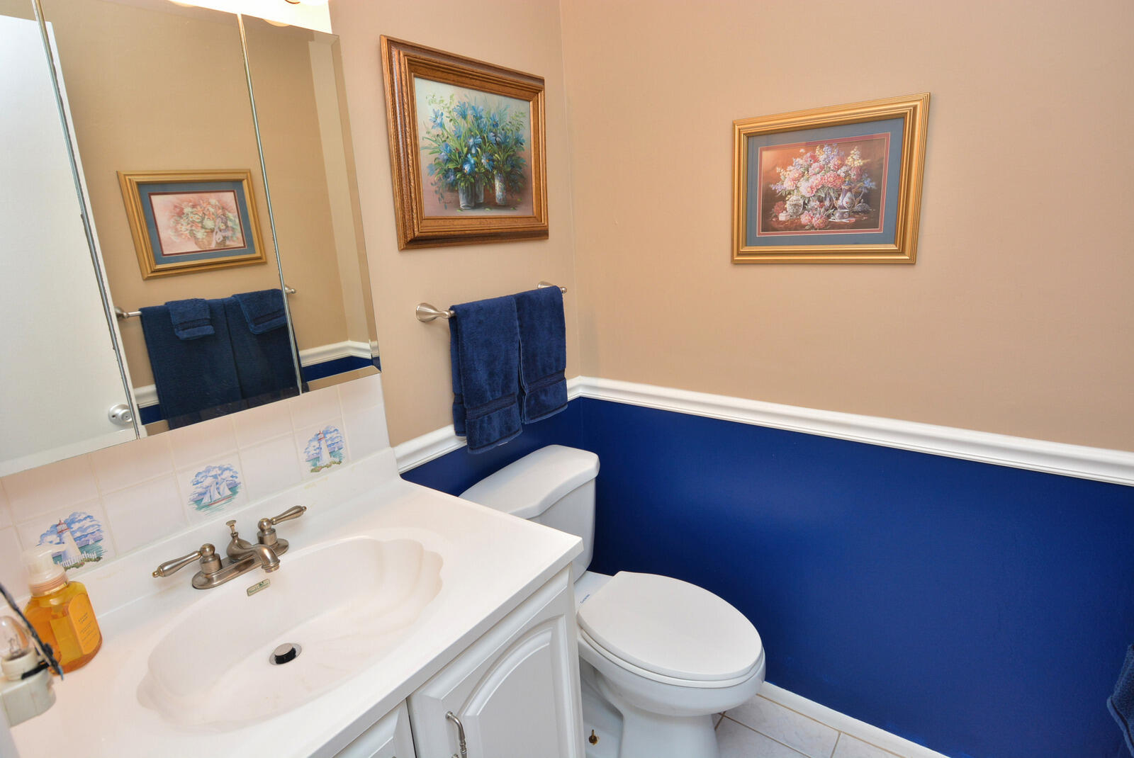 1225 Northwest 21st Street, Unit 2003 Stuart, FL 34994 - Photo 12 of 30 a bathroom with a toilet a sink and mirror