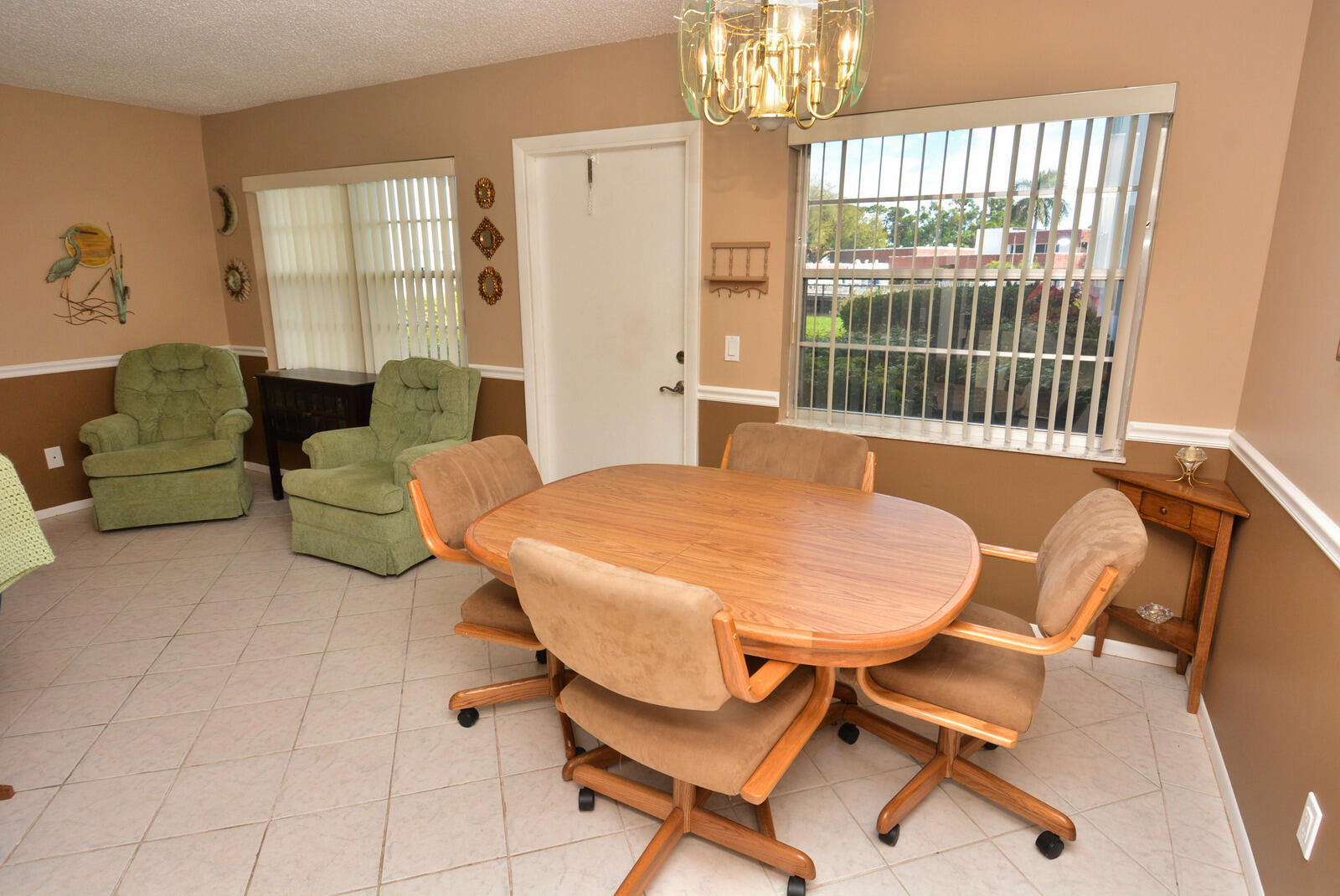 1225 Northwest 21st Street, Unit 2003 Stuart, FL 34994 - Photo 5 of 30 a living room with furniture and a chandelier