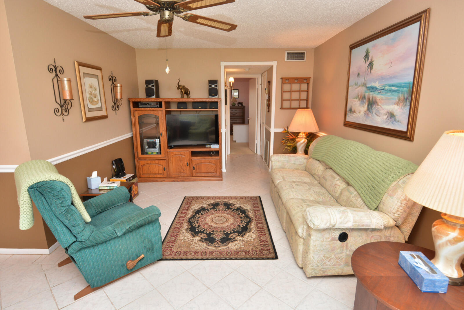 1225 Northwest 21st Street, Unit 2003 Stuart, FL 34994 - Photo 7 of 30 a living room with furniture and a flat screen tv