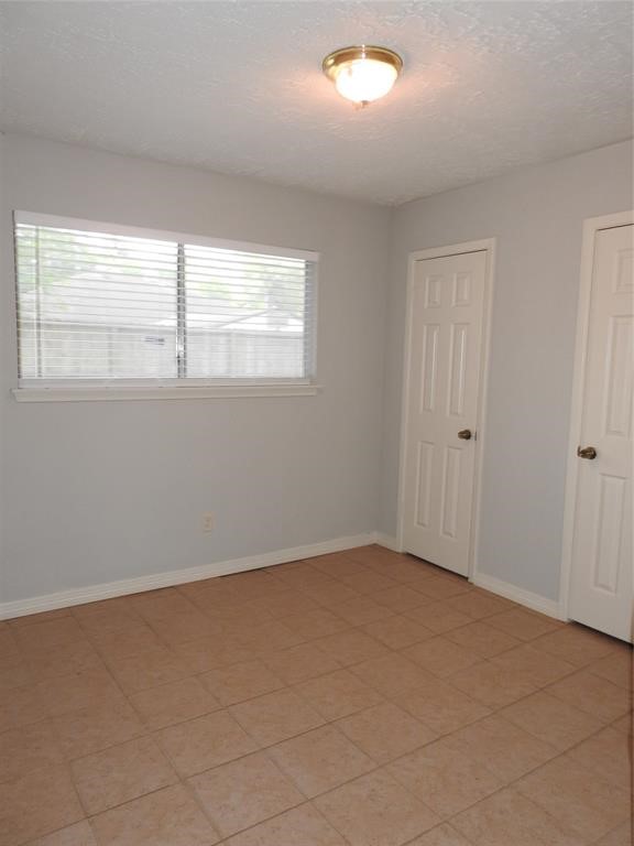 19902 Bishops Gate Lane Humble, TX 77338 - Photo 11 of 15 an empty room with a window