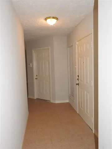 a view of hallway with closet