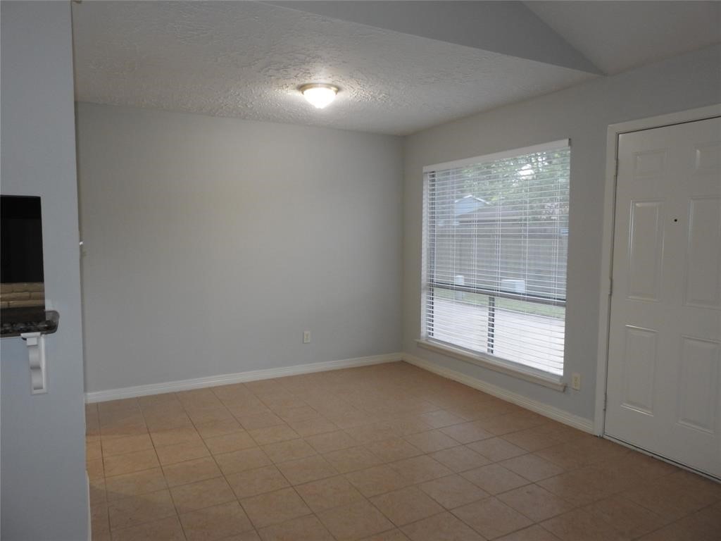 19902 Bishops Gate Lane Humble, TX 77338 - Photo 4 of 15 an empty room with windows