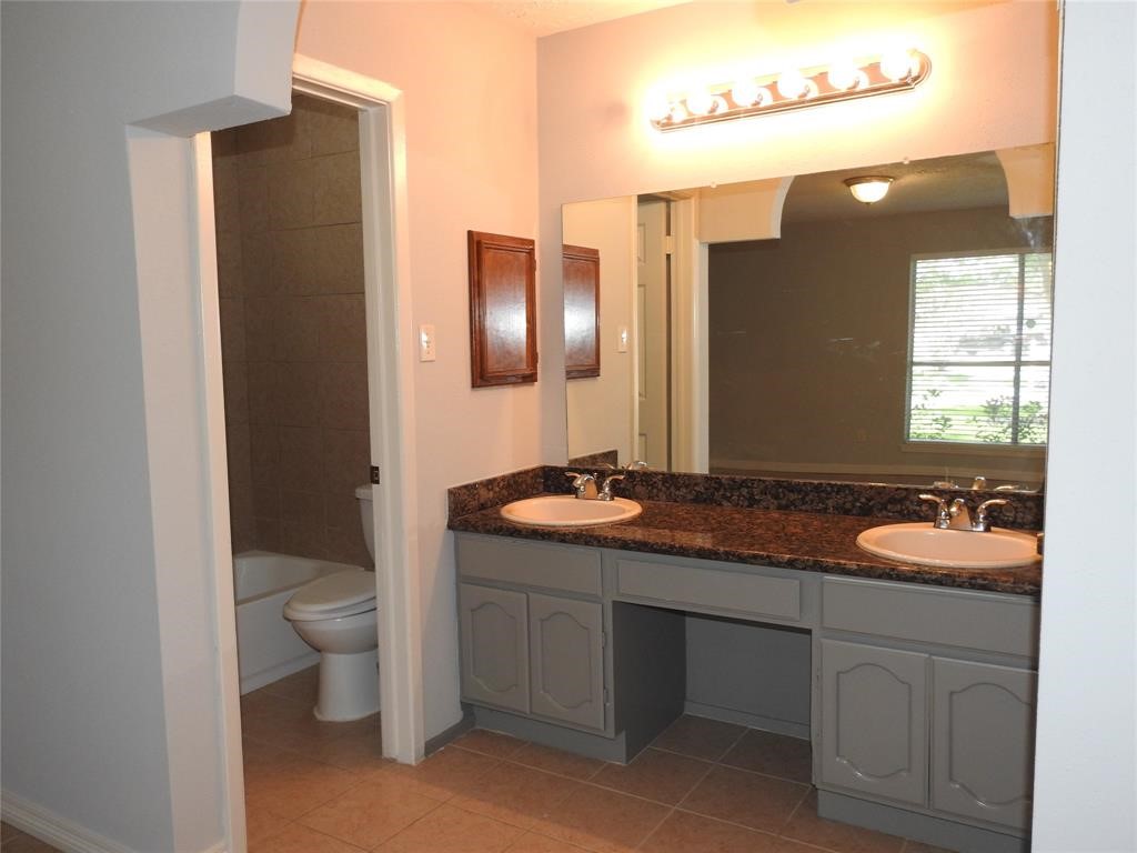 19902 Bishops Gate Lane Humble, TX 77338 - Photo 8 of 15 a bathroom with a granite countertop sink toilet and mirror