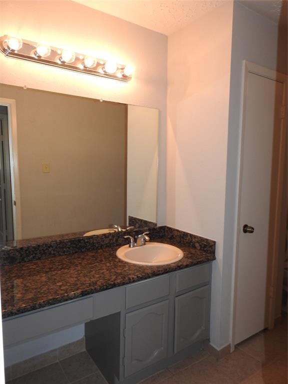 19902 Bishops Gate Lane Humble, TX 77338 - Photo 9 of 15 a bathroom with a granite countertop sink and a mirror