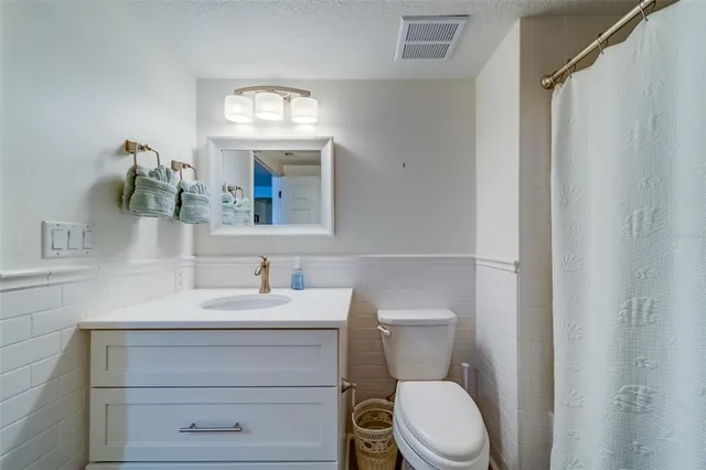 a living room with furniture a flat screen tv and a table