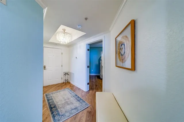 a kitchen with granite countertop white cabinets and a wooden floor