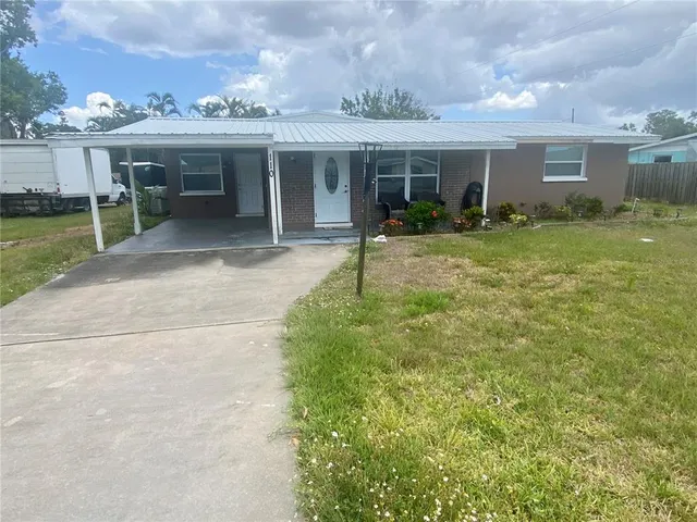 a view of a house with backyard porch and sitting area
