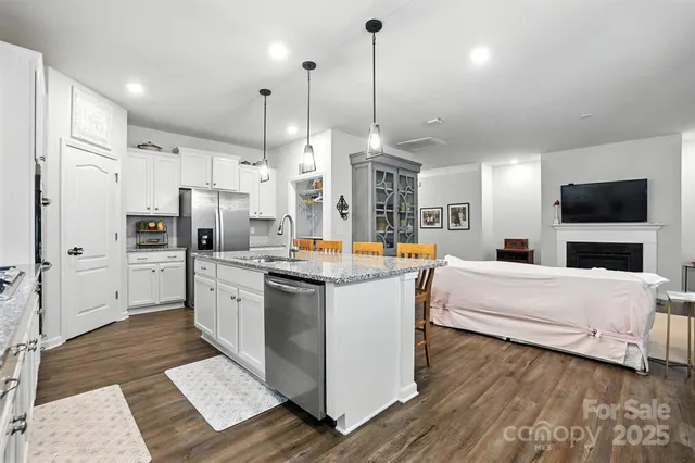 a large white kitchen with stainless steel appliances