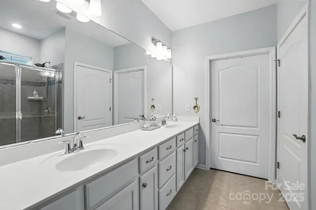 a bathroom with a double vanity sink mirror and double