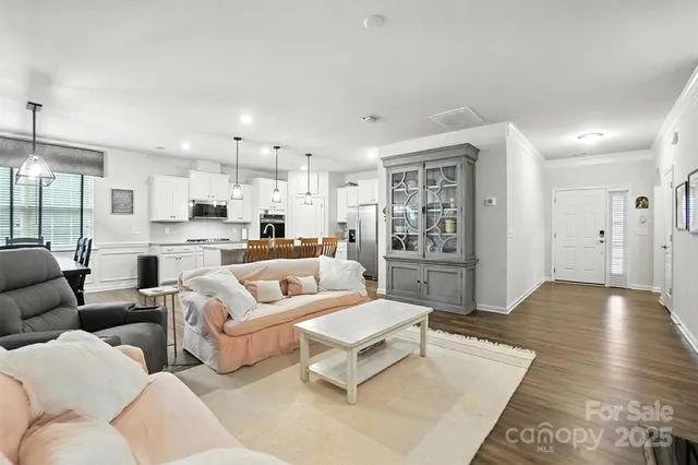a living room with furniture and kitchen view