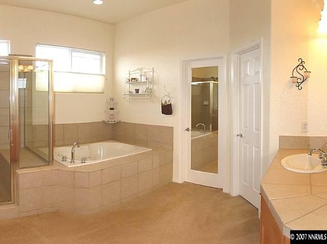 1626 Moquith Court Reno, NV 89521 - Photo 8 of 9 a bathroom with a tub a sink and a shower