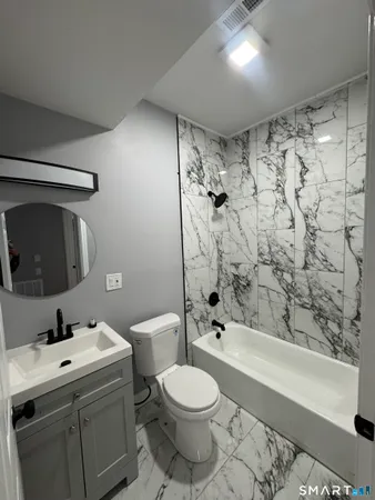 a bathroom with a sink toilet and shower