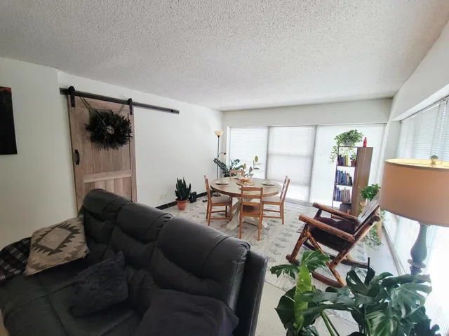 a view of a livingroom with wooden floor and stairs