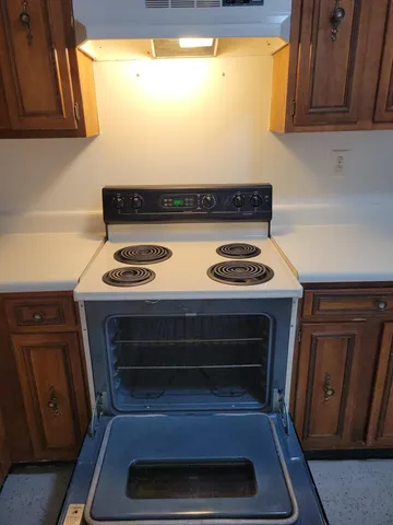 a kitchen that has a sink and a stove in it