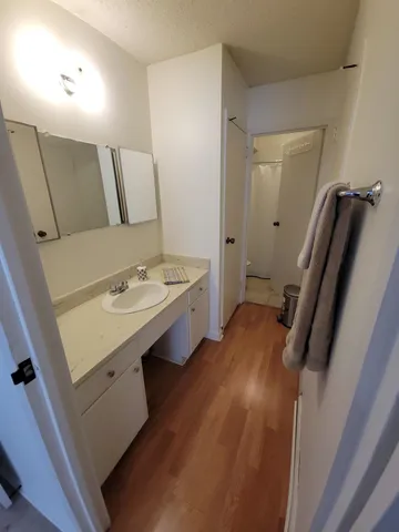 a view of a hallway with wooden floor