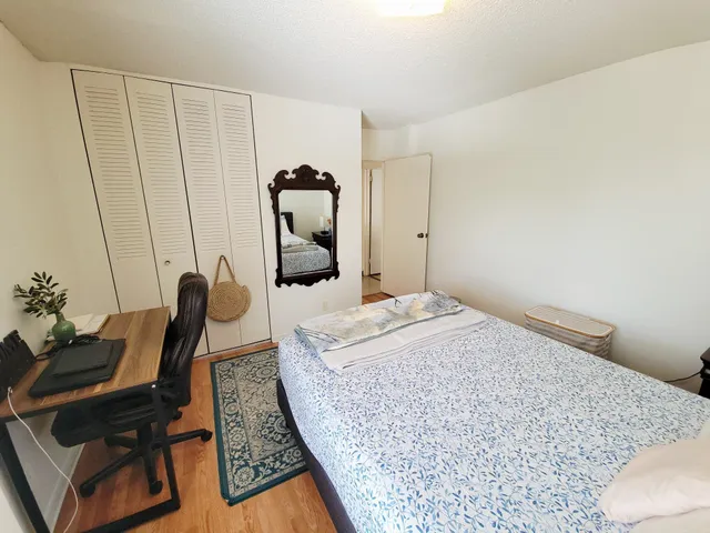 a bedroom with a bed a couch and dresser