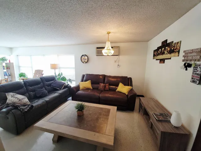 a living room with couches and a flat screen tv