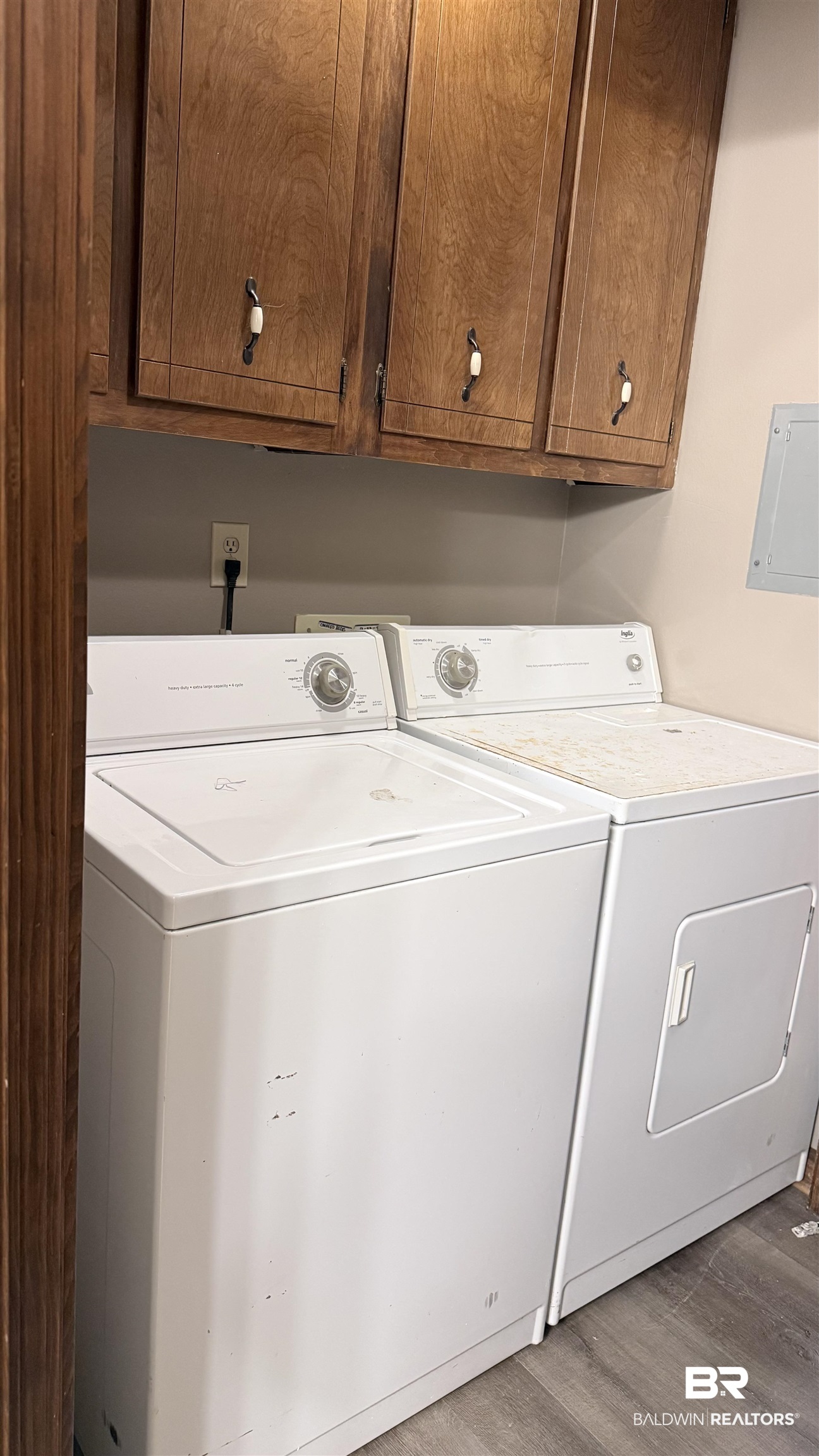 4131 Springdale Road Mobile, AL 36609 - Photo 19 of 28 Laundry room with cabinet space, light wood finished floors, washing machine and dryer, and electric panel