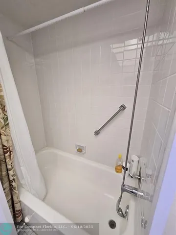 a bathroom with a toilet and a mirror