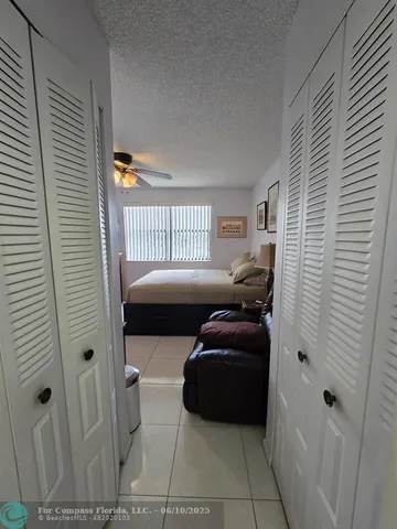 a bedroom with a bed dresser and a window