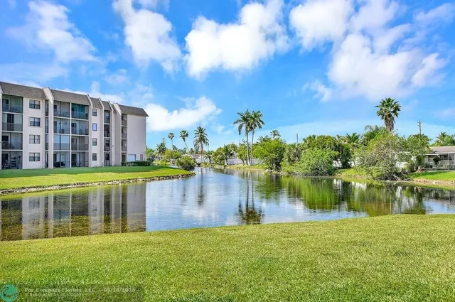 a view of a lake with houses in the back