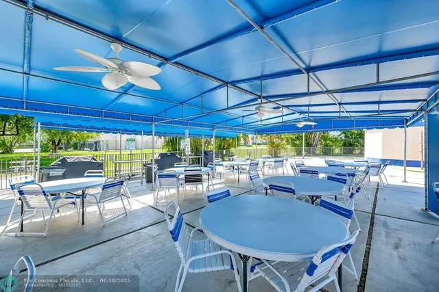 a view of a lake with a bench in the patio
