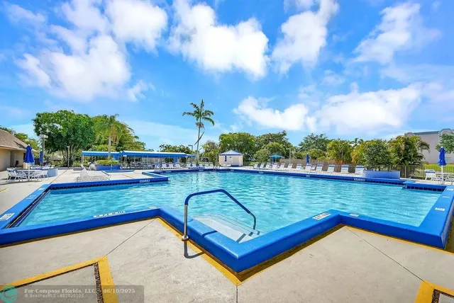 a view of a swimming pool with a patio