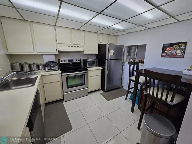 a kitchen with a stove refrigerator and sink