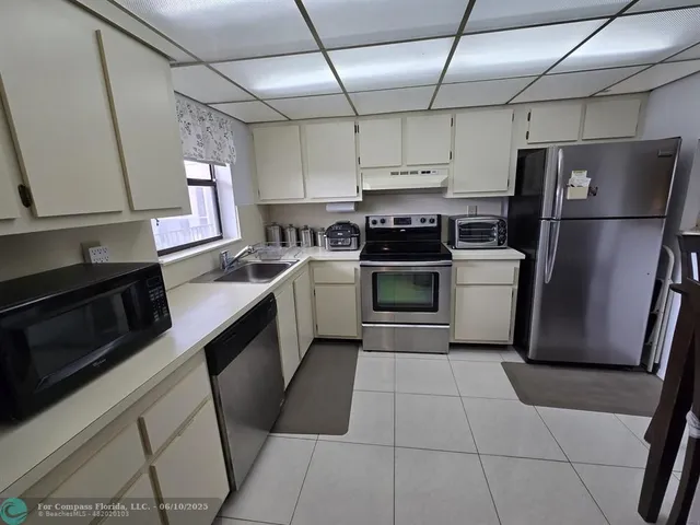 a view of a kitchen with electric appliances
