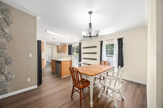 a dining room with furniture and wooden floor