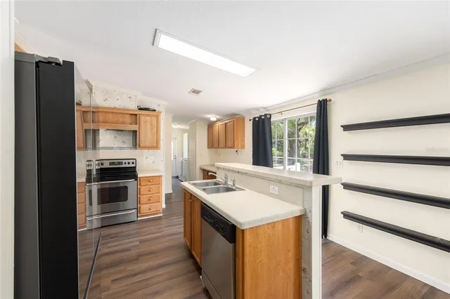 a kitchen with a sink stove and refrigerator