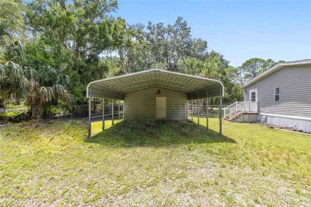 a view of a house with a yard and lake