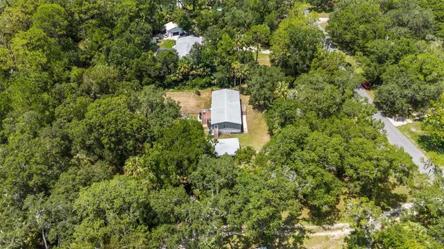 an aerial view of a house with a yard and garden