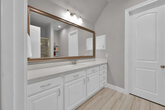 a bedroom with a bed and large windows