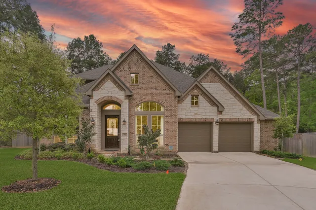 a front view of a house with plants