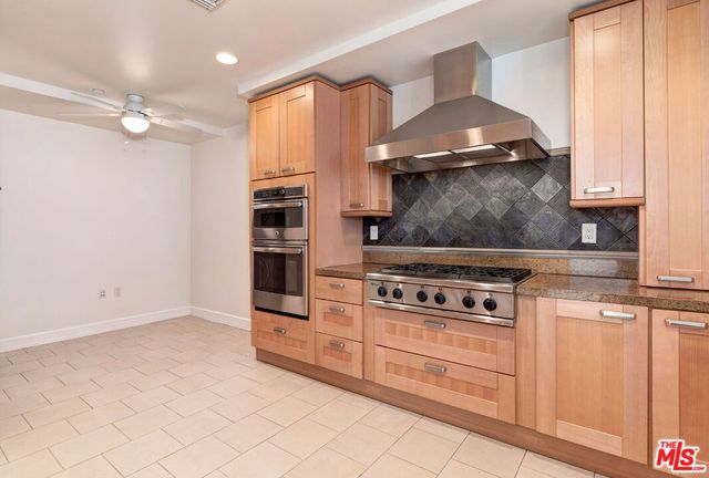 a kitchen with granite countertop a stove and a sink