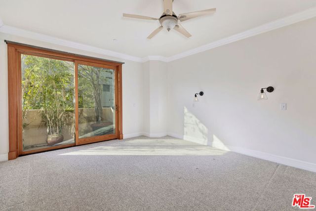 a view of a livingroom with an empty space and balcony ceiling fan