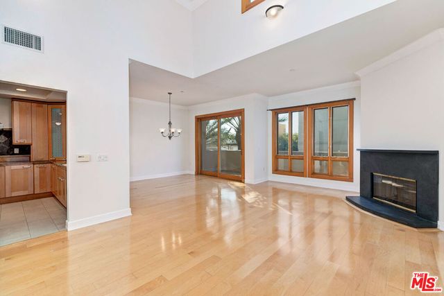 a view of an empty room with window and fire place