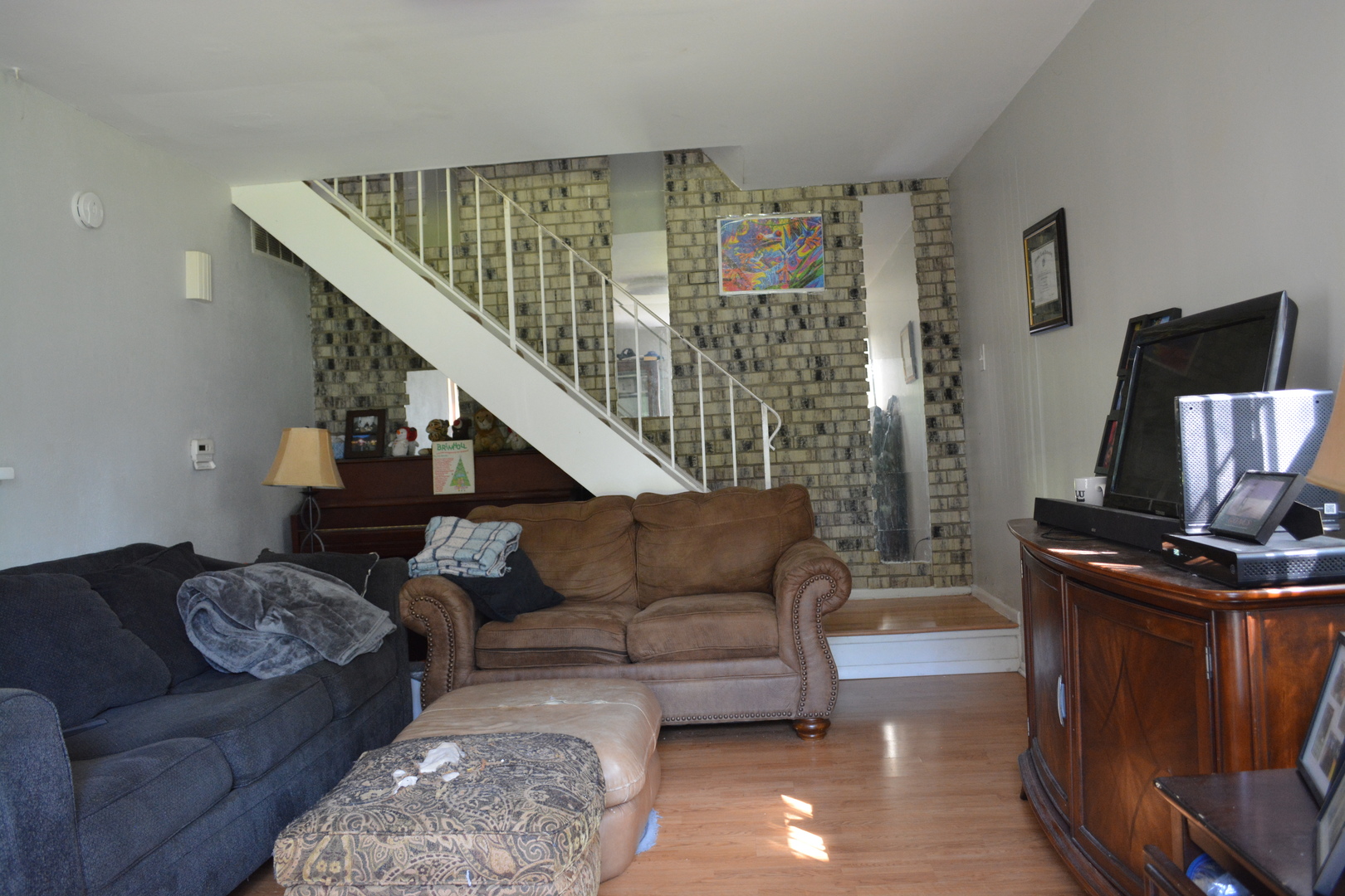 1319 Exeter Court Wheeling, IL 60090 - Photo 2 of 9 a living room with furniture and a flat screen tv