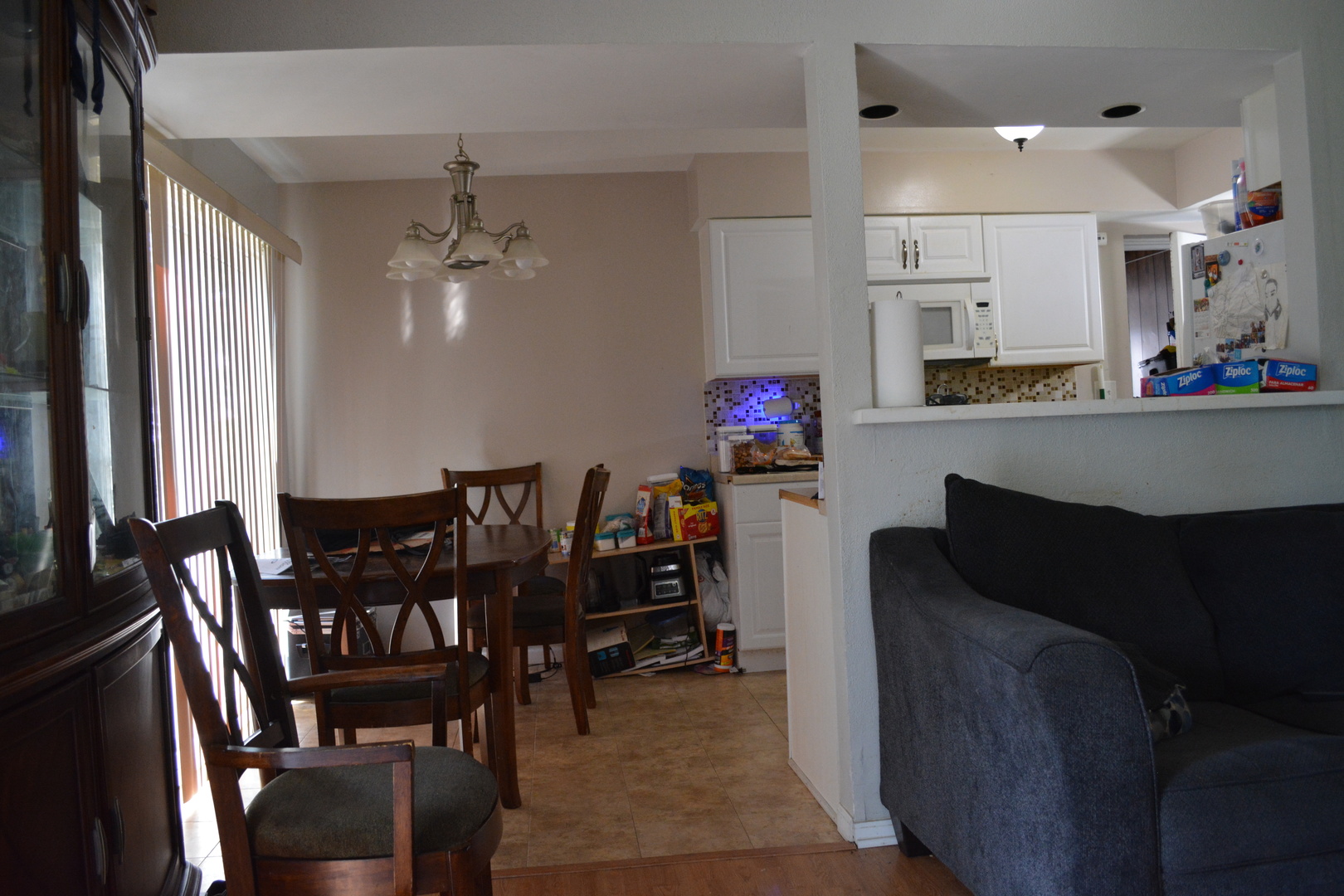 1319 Exeter Court Wheeling, IL 60090 - Photo 5 of 9 a living room with furniture and a dining table with kitchen appliances