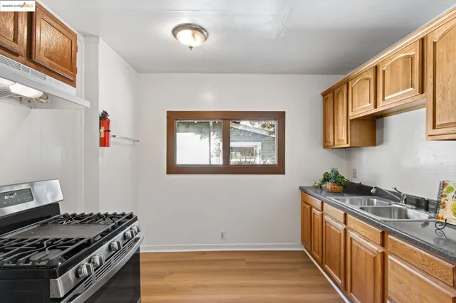 a kitchen with stainless steel appliances granite countertop a stove and a sink