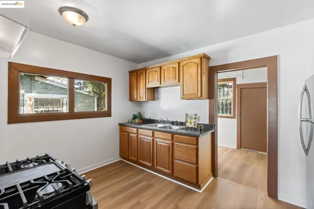 a kitchen with stainless steel appliances granite countertop a stove and a refrigerator