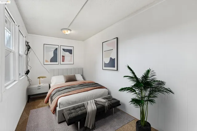 a bedroom with bed and a potted plant