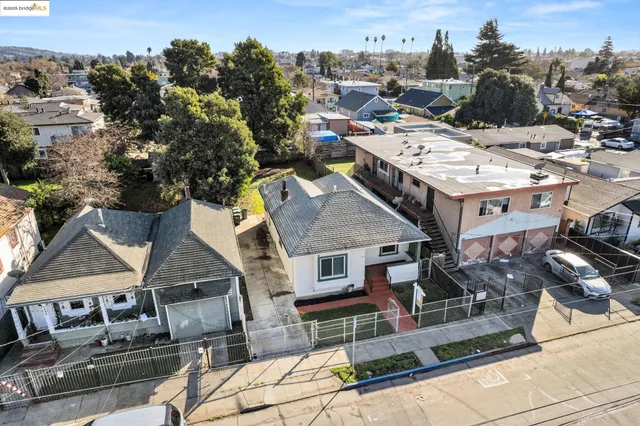 an aerial view of multiple houses with outdoor space