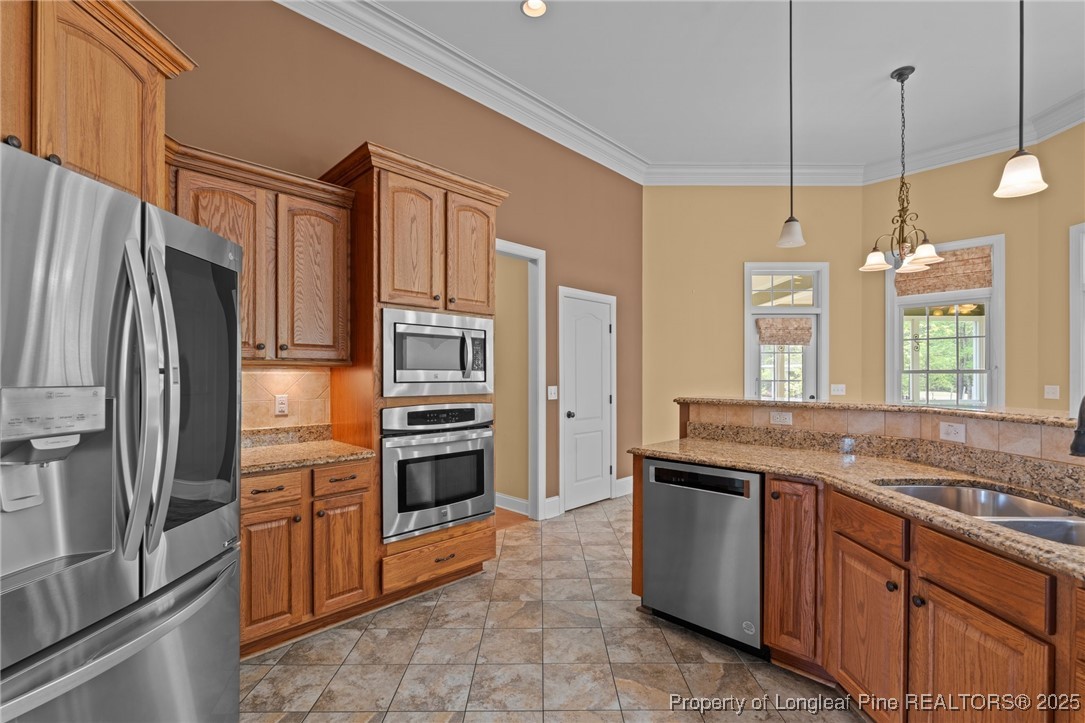 30 Spring Pond Lane Spring Lake, NC 28390 - Photo 19 of 35 a kitchen with stainless steel appliances granite countertop a refrigerator and a sink