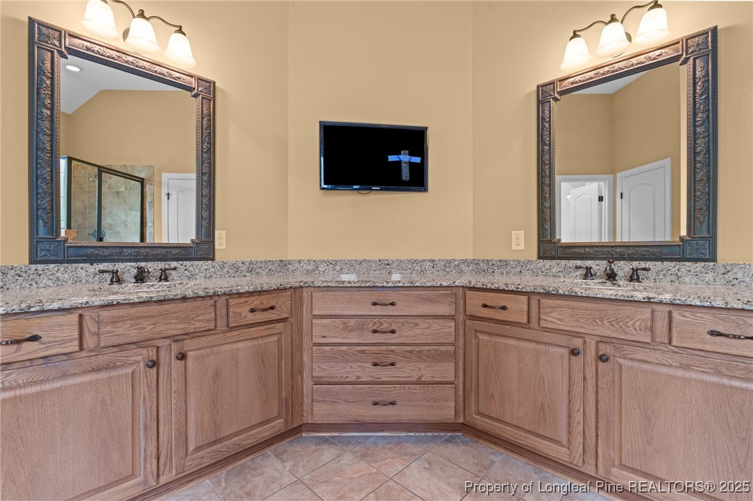 30 Spring Pond Lane Spring Lake, NC 28390 - Photo 26 of 35 a bathroom with a sink and two mirror