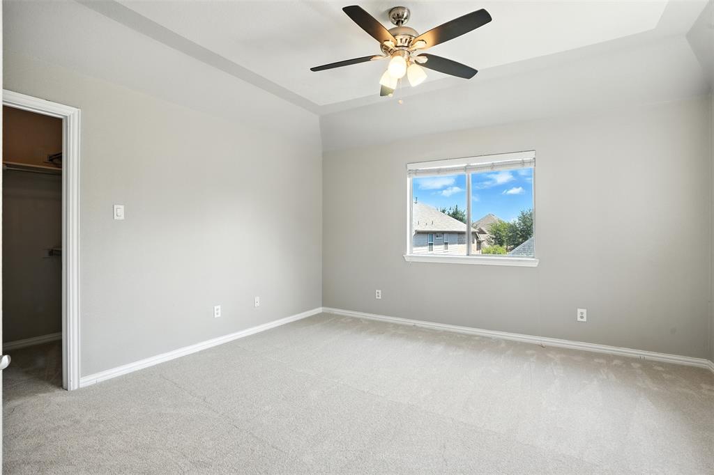 8220 Holliday Road Lantana, TX 76226 - Photo 31 of 40 Spacious room with tray ceiling and light gray walls