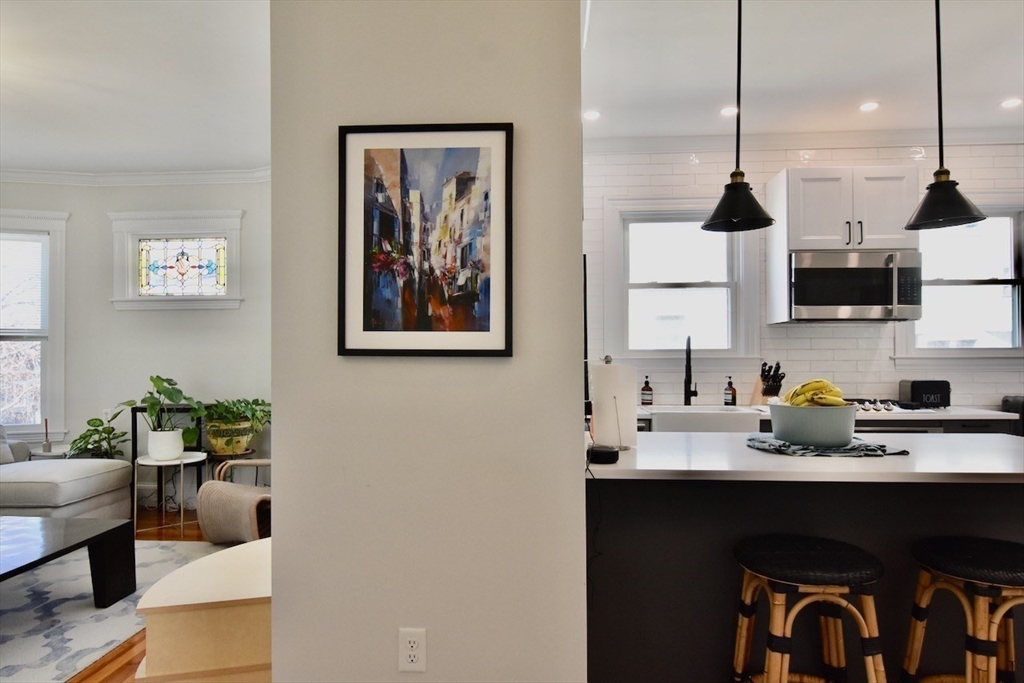 14 Castlerock Street, Unit 14 Boston, MA 02125 - Photo 16 of 32 a kitchen with stainless steel appliances a sink refrigerator and microwave