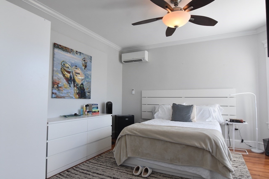 14 Castlerock Street, Unit 14 Boston, MA 02125 - Photo 19 of 32 a bedroom with a bed and a chandelier