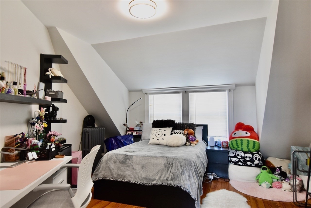 14 Castlerock Street, Unit 14 Boston, MA 02125 - Photo 24 of 32 a bedroom with a bed and a potted plant